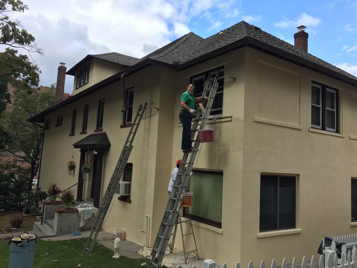 Jimmy Tahiraj on a ladder at a residential job site