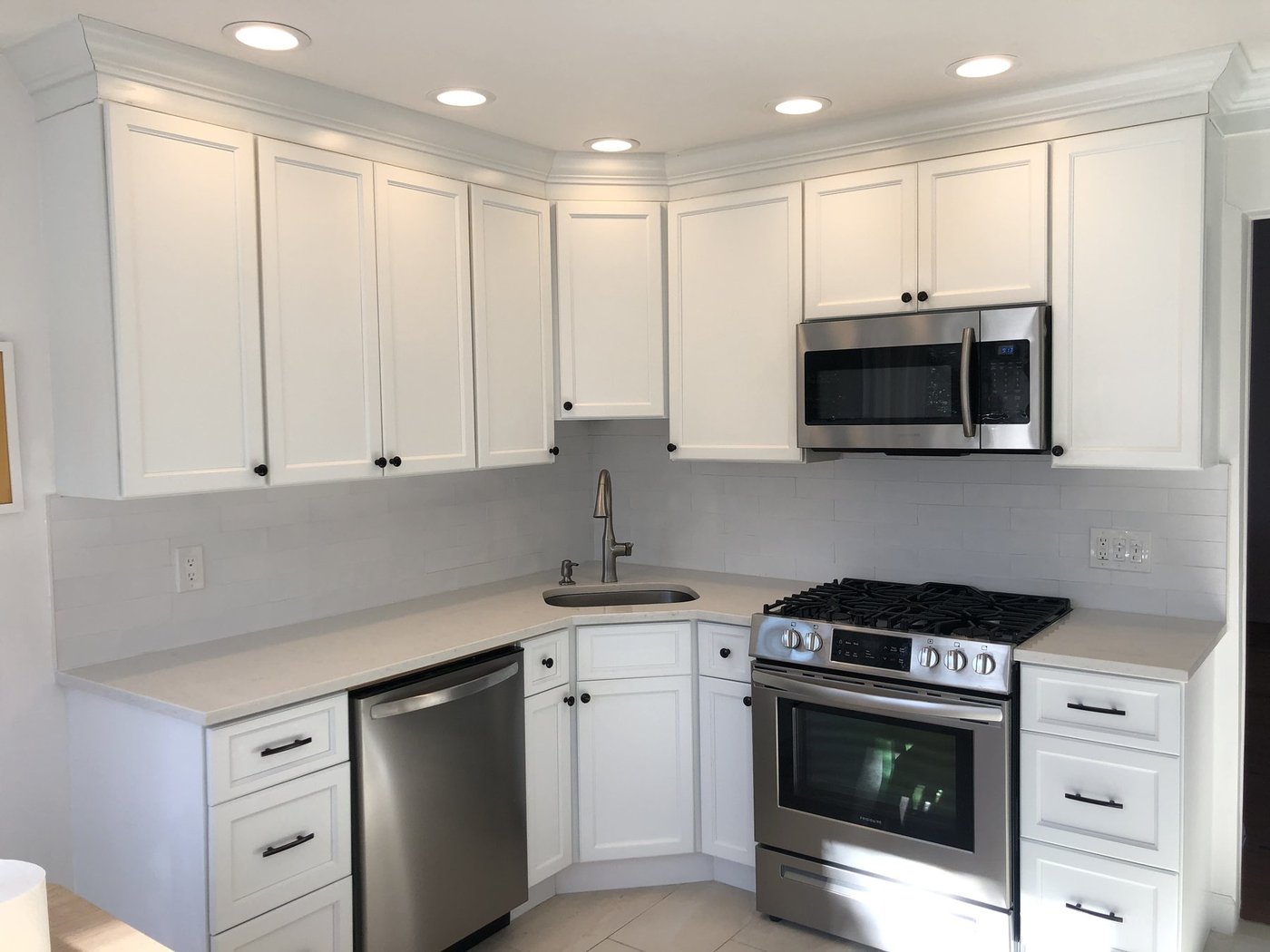 Classic kitchen with white shaker cabinets and subway tile backsplash